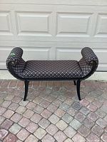 Front view of bench showing diamond lattice upholstery and rolled arms