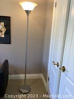 Full view of the 70-inch floor lamp standing next to a wall and door, showing overall height and style.
