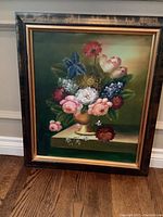 Frontal view of the framed floral painting showing the bouquet arrangement and frame detail.