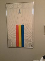 Framed poster on wall, showing full artwork and frame