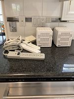 Photo of two Tripp Lite LC 1200 line conditioners with power strips on black countertop.