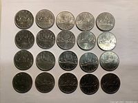 20 Canadian Voyageur dollar coins arranged 5x4 on white background