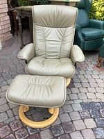 Full view of chair and ottoman showing overall design and condition