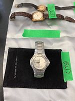 Front view of Tag Heuer Kirium watch on black David Yurman pouch with green tape “176”