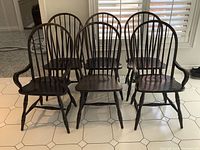 Front view of six chairs arranged in two rows, showing two armchairs at ends and four side chairs between.