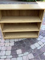 Front facing view of the bookcase showing the three shelves with the middle shelf adjustable.