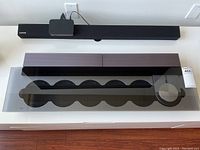 Top-down view of glass-covered CD carousel and control knob