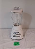 Photo of Oster kitchen blender showing entire unit including glass pitcher and white base with control panel.