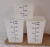 Four food grade plastic pails shown: two 20-liter and two 10-liter, square shape, translucent white with blue volume markings in liters and quarts.