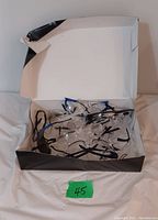 Box containing 15 pairs of clear lens safety glasses with black and blue temples.