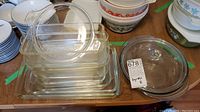 View of stacked clear glass rectangular and round Pyrex dishes, some with lids