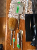 Overview of four Birks sterling silver vanity items on wood table