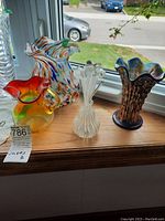 All four glass vases displayed on windowsill
