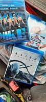 Three Blu-ray DVD cases showing titles Magic Mike, The Flight Attendant, and Alien: Covenant packed together.