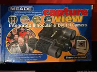 Photo of the original product box showing Meade CaptureView integrated binocular and digital camera with key product features and images.