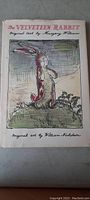 Front cover of hardback book with paper jacket, showing hand-drawn illustration of rabbit and title The Velveteen Rabbit by Margery Williams