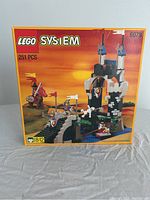 Front of the box of the LEGO System Royal Drawbridge set 6078 showing 251 pieces, castle with flags, knights, and horses under an orange sunset background.