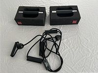 Pair of black foam push up bars with padded handles and black resistance bands with plastic handles.