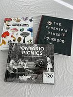 Three books displayed on a white surface: Mushrooming, The Phoenicia Diner Cookbook and Ontario Picnics.