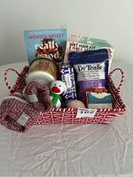 Full view of the pamper gift basket contents in red and white patterned basket.