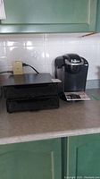 Keurig K50 Classic coffee maker with two black pull-out drawer pod holders on a kitchen counter.