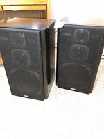Pair of Yamaha NS-30X speakers side by side on carpet