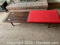 Front view of bench with red cushion