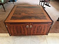 Front view of the square wooden cabinet showing double doors with woodgrain pattern and metal handles