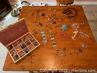 Table displaying all jewelry pieces and jewelry box, showing overall lot contents