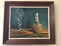 Full view of the framed painting showing the still life artwork with bottle and smoking pipe.