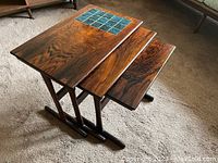 Three nesting tables stacked largest to smallest showing tile inlay