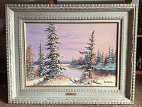 Photo of the full framed painting showing the snowy landscape scene with trees and bay under a pink sky.