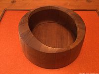 Top and angled view of round wooden serving bowl showing wood grain, shape, and condition.