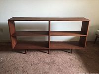 Full front view of shelving unit showing overall shape and compartments