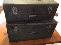Photo showing two stacked Craftsman metal tool boxes in used condition with latch closures.
