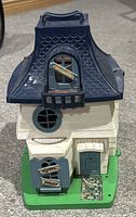Front view of the vintage 1976 Hasbro Weebles Haunted House showing windows, door, and sign details.