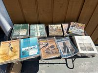 Image showing multiple bound and loose Ducks Unlimited magazines arranged on a surface, including green binders and individual issues with wildlife cover art.