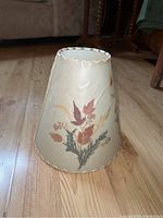 Side view of the lamp shade showing pressed leaves decoration and stitched edge
