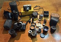 Full overview of all cameras, lenses, cases and accessories arranged on table