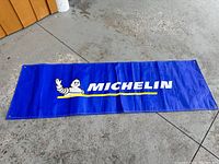 Full view of blue Michelin vinyl banner laid out flat.