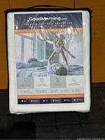 Mattress protector in white folded and sealed in original packaging showing front label with usage and features.