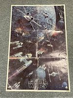 Full view of the 1977 Star Wars movie poster showing space battle with starfighters and the Star Wars logo at the bottom.