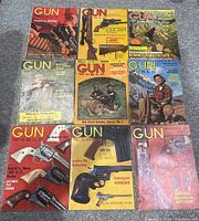 Nine 1960s Gun World magazines laid out showing covers with firearms and hunting scenes.