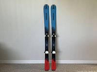 Front view of pair of Atomic Vantage junior skis, 130cm, showing top sheet design and bindings mounted.