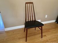 Three-quarter front view of full chair showing frame, backrest and seat upholstery