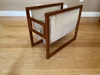 Front perspective view showing overall design, teak frame, and linen sling