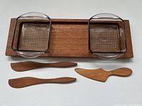 Photo showing the teak tray with two glass dishes and three wooden spreaders laid out on a white surface.
