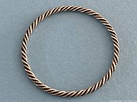 Full view of twisted rope bangle on neutral background