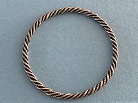 Full top-down view of the twisted rope bangle on blue background