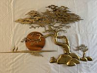 Full view of entire unfolded sculpture laid flat on cloth background